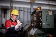 © APchanel - Engineer or factory worker wearing safety uniform under checking a metal part of lathe produce is quality control of parts machined on lathe structure Manufacturing industrial.