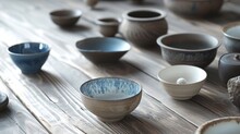 A Group Of Bowls Sitting On Top Of A Wooden Table Next To Rocks And A Bowl With A Spoon In It.