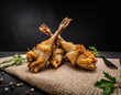 frog legs baked placed dark on eco fabric, product photography, food, restaurant, macro, black background