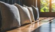 closeup upholstery pillow soft and comfort cushion line of decorating pillow on wooden floor with sun light bright and shade home inerior design design house element background