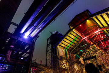 Poster - Landschaftspark Duisburg-Nord by night with all coloured buildings.