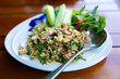 Spicy minced pork salad on wood table, Thai style food.