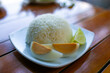 Rice in white plate with sliced lime and egg on wooden table