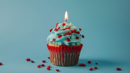 Poster - Red sprinkles and a lit candle are on top of a blue cupcake.
