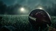 American football ball on a field at night in high resolution and sharpness