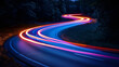 © Evgeniia - Light traces from a car paint a mesmerizing pattern on a winding bend in the road, capturing the dynamic movement and fluidity of the vehicle's journey through the scenic route.