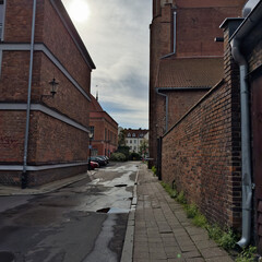 Sticker - Empty cobblestone street with the facade of an old building