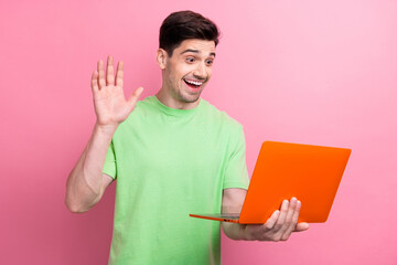 Poster - Photo of young friendly guy waving hand to his teammates at project he has online conference online isolated on pink color background