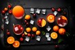 Tequila Sunrise cocktail, orange, ice cubes, maraschino cherries and jigger on a wet black slate tray. Cocktail Set. Top view with space for your text