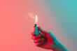person holding a lighter next to a pink background in