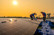© ultramansk - Male workers repair Floating solar panels on water lake. Engineers construct on site Floating solar panels at sun light. clean energy for future living. Industrial Renewable energy of green power.
