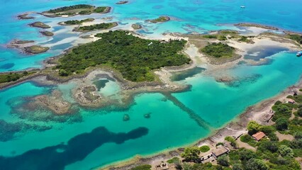 Canvas Print - Aerial drone video of tropical exotic volcanic island forming an azure blue lagoon and paradise sandy beaches in Caribbean destination