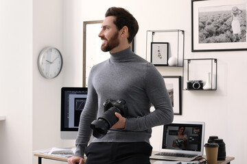 Poster - Professional photographer with digital camera near table in office