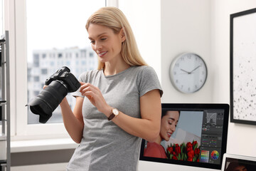 Canvas Print - Professional photographer with modern digital camera in office