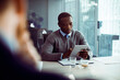 © Davor - Businessman sitting in conference room meeting