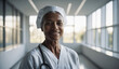 © EliteLensCraftImages - Confident Old Canadian Female Doctor or Nurse in Clinic Outfit Standing in Modern White Hospital, Looking at Camera, Professional Medical Portrait, Copy Space, Design Template, Healthcare Concept
