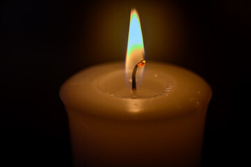 Candlelight in darkness. Soft warm light.