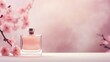 © Kate - glass perfume bottle on a light pink background with sakura branches