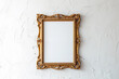 © Iryna - Vintage vertical gold frame hanging on white wall. Golden frame for mock up.