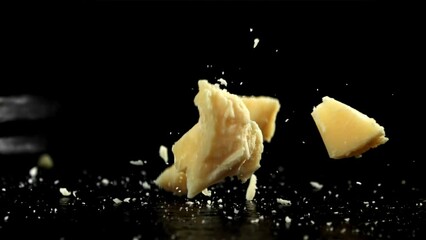 Canvas Print - Parmesan cheese falling on a black background. Filmed on a high-speed camera at 1000 fps. High quality FullHD footage