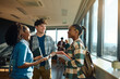 © Drazen - Multiracial group of happy college students talking in classroom.