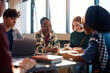 © Drazen - Happy black college student and her friends studying in classroom.