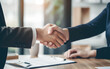 © Blockbits - Handshake Success: Bank Representatives and Clients Seal Property Deal