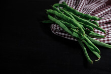 Raw Fresh String Green Beans In Organic Paper Bag On Black Wooden Background