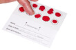 Blood Spot test card with droplets of blood for hormone testing