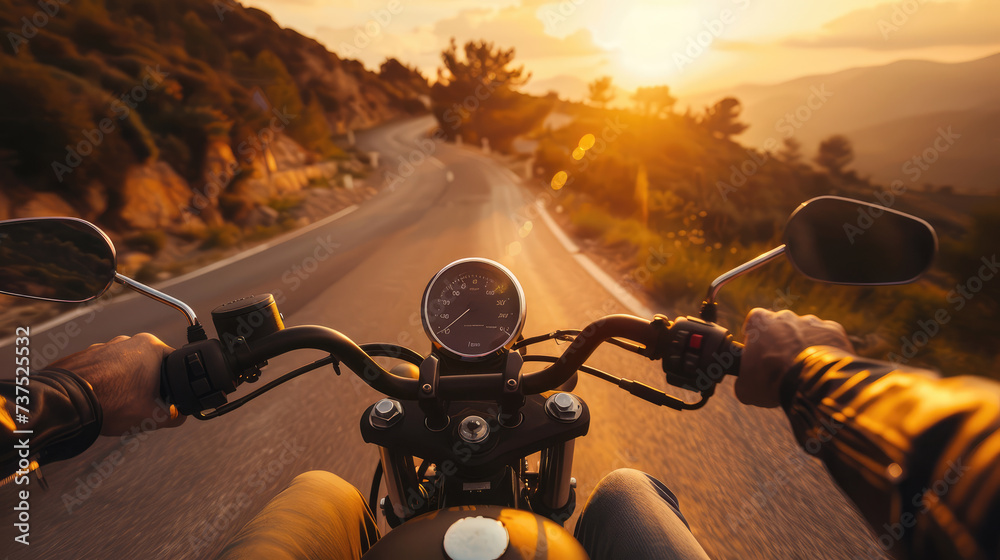 First-person view of a motorcycle ride on a winding road at sunset ...