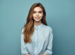 © Marharyta Tsapenko - Happy young girl in blue shirt with vibrant blue background.