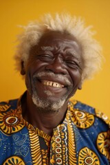 Poster - A picture of a man with white hair smiling and wearing a blue and yellow shirt. Suitable for various uses