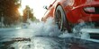 A close up view of a red car on a wet road. This image can be used to depict rainy weather or driving conditions