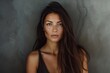 © LimeSky - Brunette woman with long straight hair poses in grey backdrop