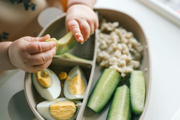 Wall Mural - first blw baby food, little baby eating organic vegetables with BLW method. Infant eating healthy food. self feeding