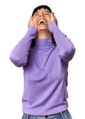 Wall Mural - Young Hispanic woman with short black hair in studio laughs joyfully keeping hands on head. Happiness concept.