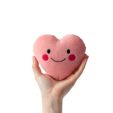 Woman’s Hand Grasping A Plush Happy Smiley Cartoon Heart Fluffy Soft Pillow In Heart Shape, Isolated On Transparent Background, PNG