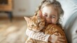 Happy toddler girl hugging her beautiful redhead cat at home with copy space. Love to the animal.