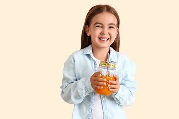 Sticker - Cute little girl with glass jar of juice on light background