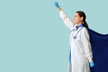 Poster - Beautiful female doctor dressed as super hero on blue background