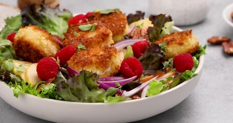 Canvas Print - Fried goat cheese salad with raspberries and red onion and green salad, camera slides