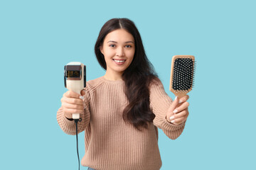 Sticker - Beautiful young Asian woman with hair dryer and brush on blue background