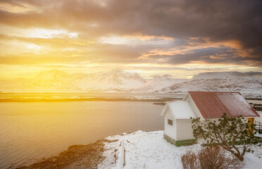 Wall Mural - norway lofoten beach red houses clouds in the air sunset light and colors