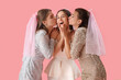 Young woman with her bridesmaids kissing on pink background. Hen Party