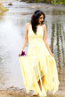 Young East Indian Woman In Yellow Dress At River