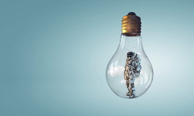 Wall Mural - spaceman inside light bulb. mixed media