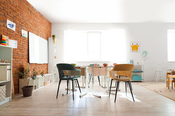 Poster - Interior of kindergarten with breakfast on tables