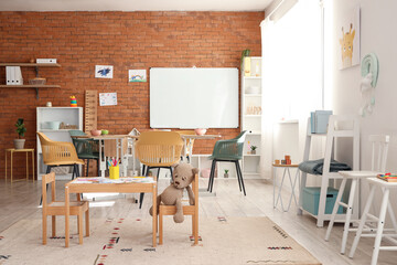 Wall Mural - Interior of kindergarten with tables and shelf units