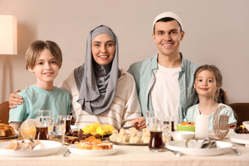 Wall Mural - Happy Muslim family having dinner at home. Ramadan celebration