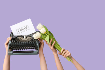 Wall Mural - Female hands with retro typewriter, greeting card and tulip flowers for International Women's Day on lilac background, closeup